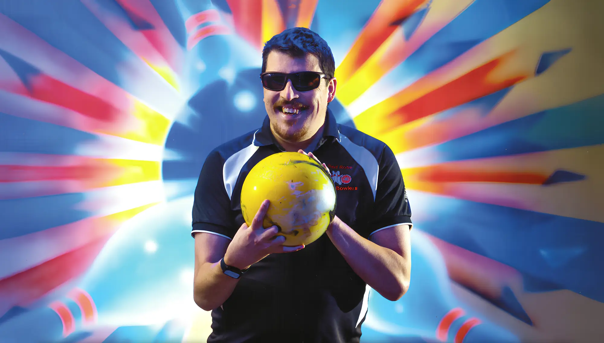 A smiling Red Rose bowler holding a yellow bowling ball against a colourful bowling backdrop.